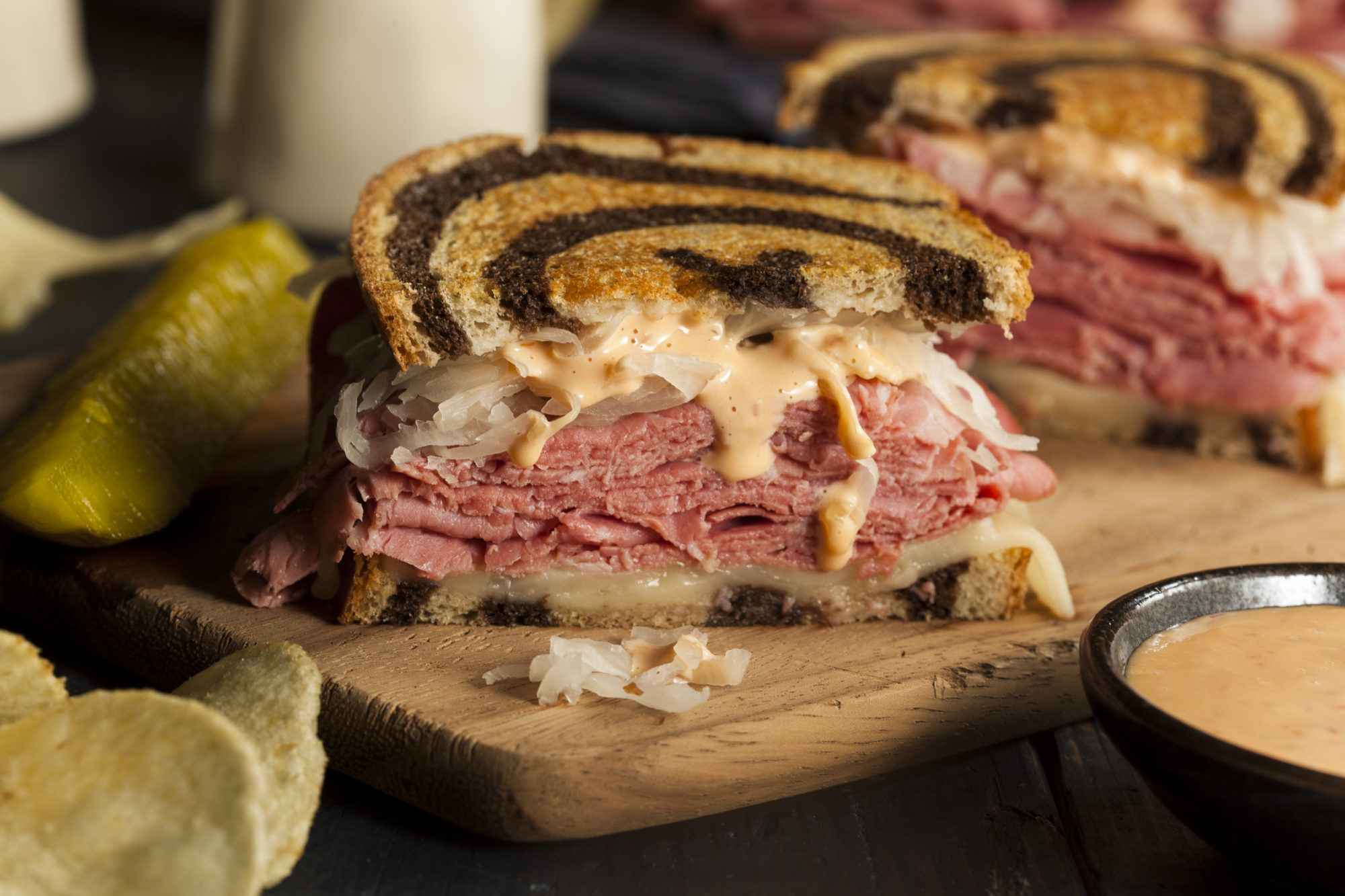 A reuben sandwich with a sauce on the side.