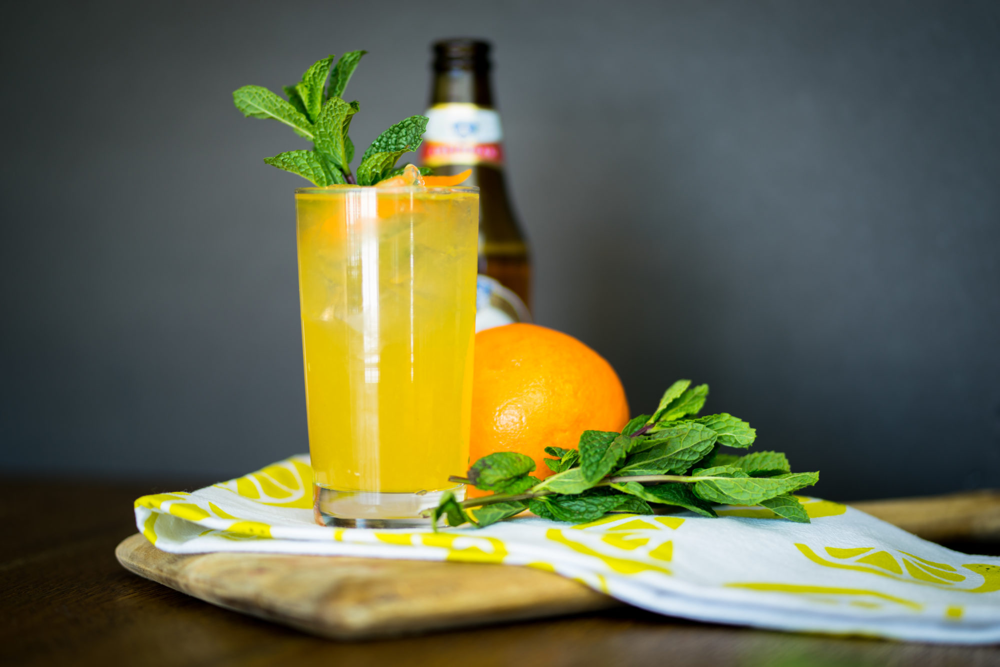 Cocktail next to an orange.
