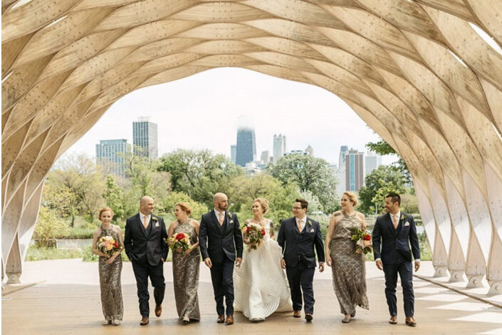 A wedding party under an archway at the Lincoln Park Zoo