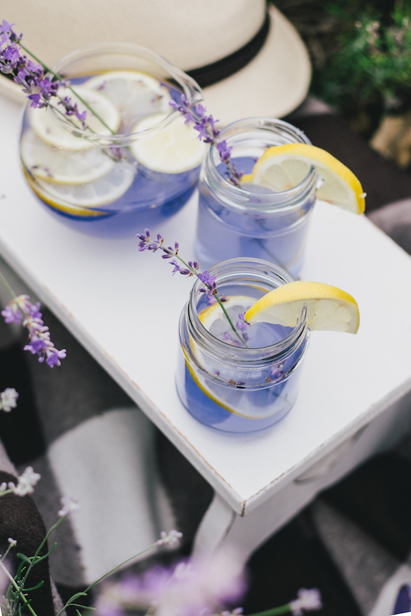Lavender-inspired cocktails, on a white plate, garnished with lemons