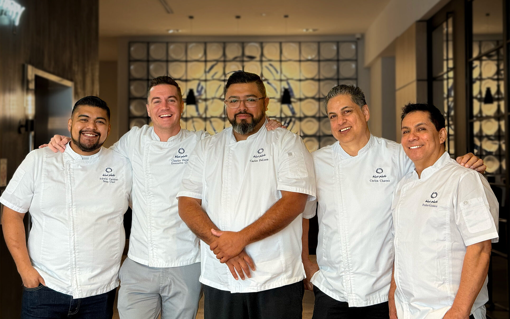 Meet the Culinary Team - Blue Plate's culinary team standing and smiling in in their chef whites.